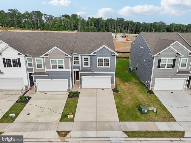 view of front of property with a garage and a front lawn