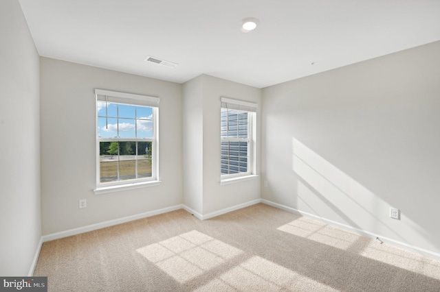 spare room with light carpet