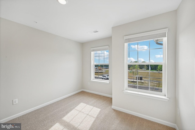 unfurnished room with light carpet