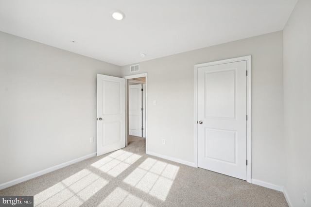 unfurnished bedroom with light colored carpet