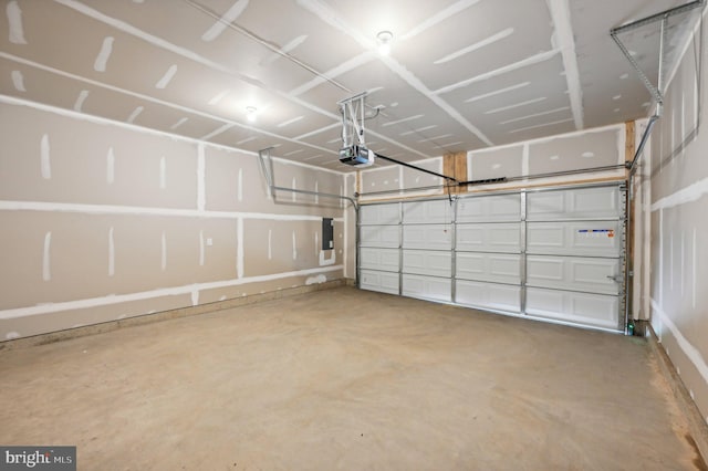 garage featuring electric panel and a garage door opener