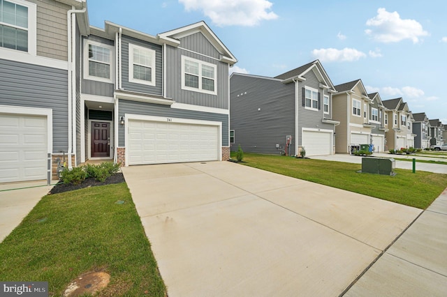 view of property featuring a front lawn and a garage