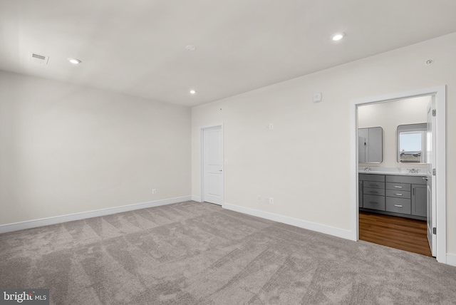 carpeted empty room with sink