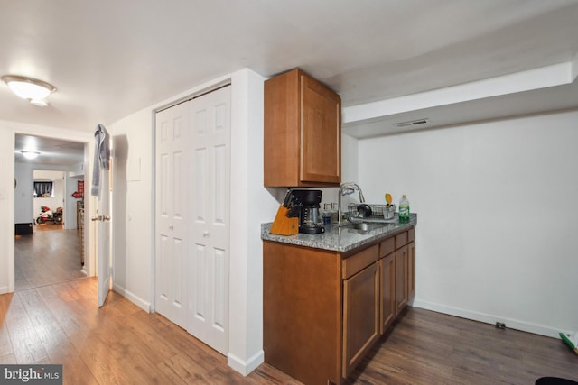 kitchen featuring sink and dark hardwood / wood-style flooring