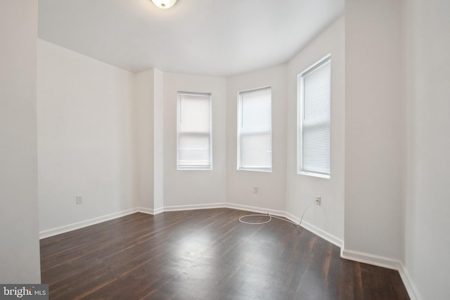 unfurnished room featuring dark hardwood / wood-style floors