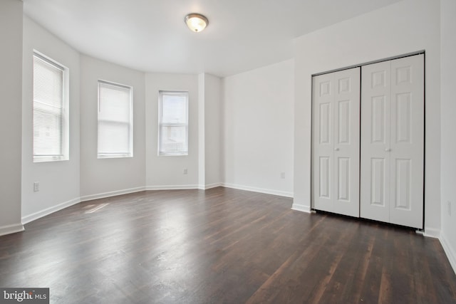 unfurnished bedroom featuring dark hardwood / wood-style floors