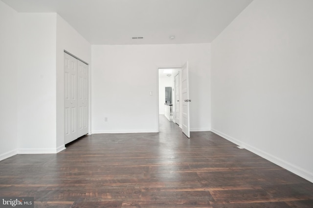 empty room with dark wood-type flooring