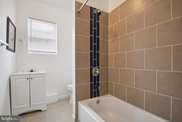 full bathroom featuring tiled shower / bath, tile patterned flooring, vanity, and toilet