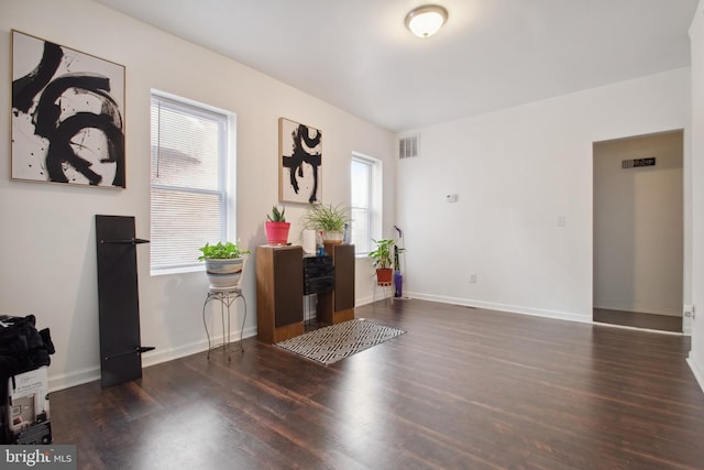 foyer entrance featuring a wealth of natural light and dark hardwood / wood-style floors