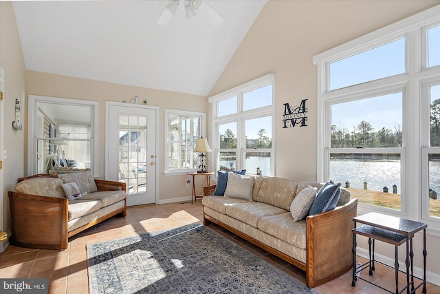 sunroom with a water view, vaulted ceiling, and ceiling fan