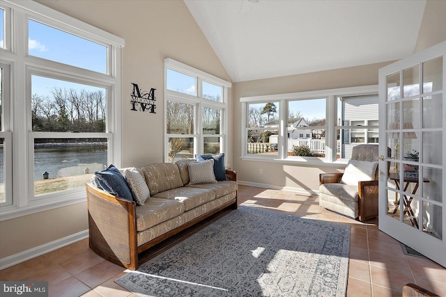 sunroom featuring a water view and lofted ceiling