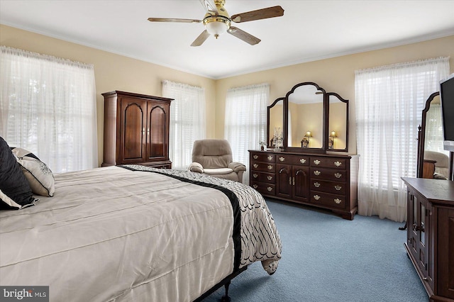 bedroom featuring ornamental molding, ceiling fan, and light colored carpet