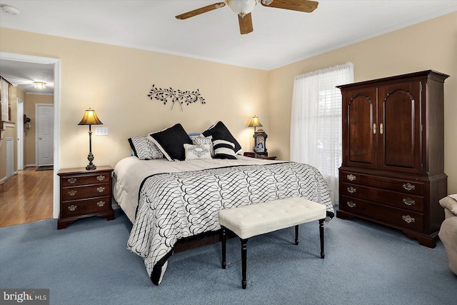 bedroom with light colored carpet and ceiling fan