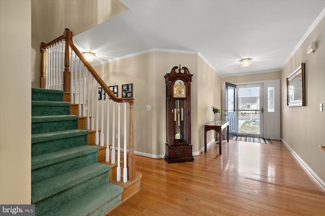 entrance foyer featuring wood-type flooring and crown molding