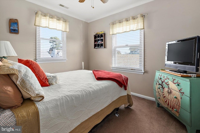 bedroom with ceiling fan, carpet, and multiple windows