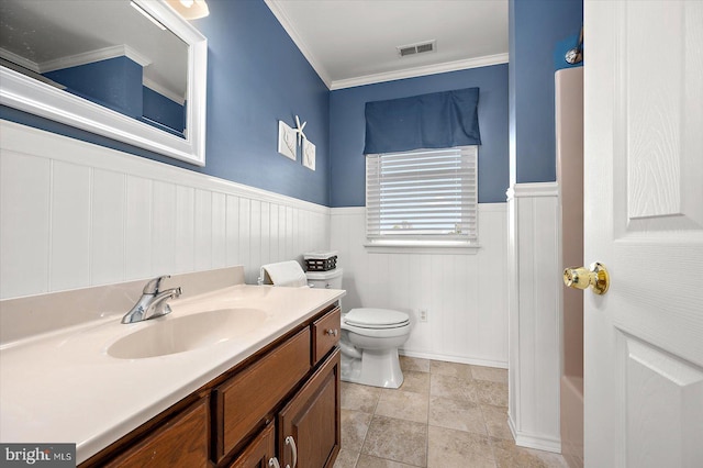 bathroom featuring toilet, vanity, crown molding, and tile patterned flooring