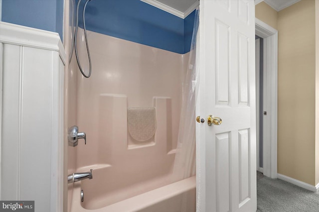 bathroom with ornamental molding and shower / bath combo