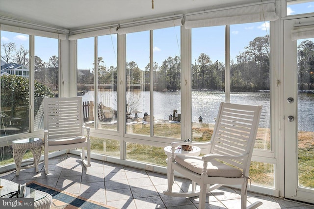 sunroom / solarium featuring a water view