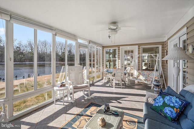 sunroom featuring a water view and ceiling fan