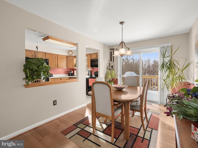 dining room featuring light hardwood / wood-style floors and a chandelier