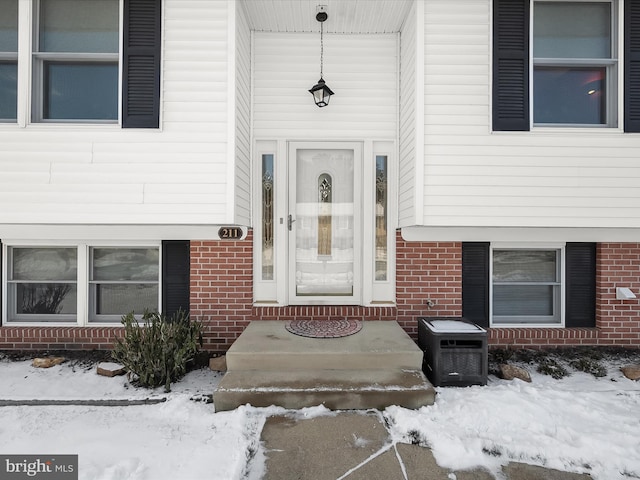 view of snow covered property entrance