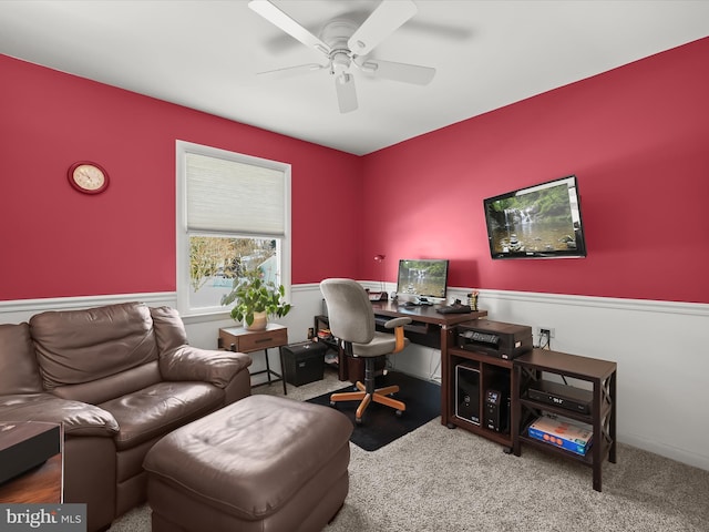 carpeted office space with ceiling fan