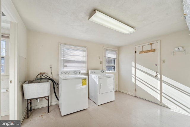 washroom featuring washing machine and clothes dryer and sink