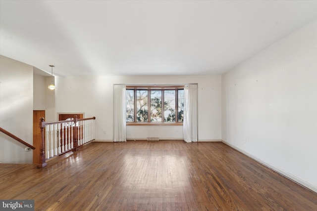 spare room featuring dark wood-type flooring