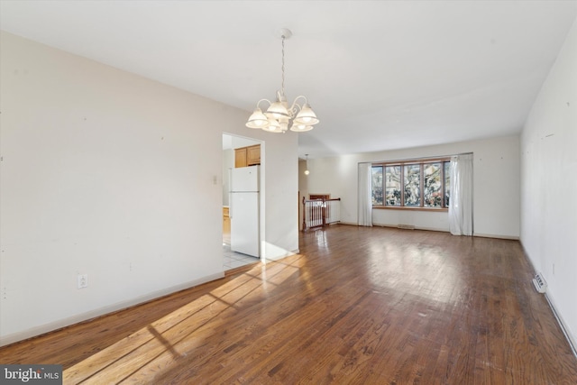 interior space featuring an inviting chandelier and hardwood / wood-style floors