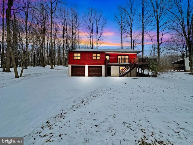 view of front of home featuring a garage and a wooden deck