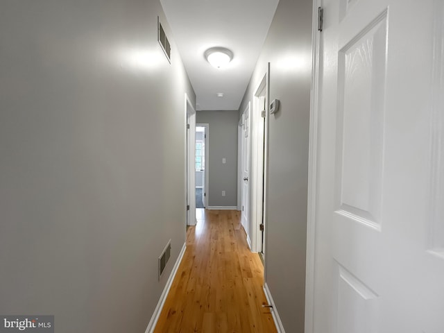 hall with light hardwood / wood-style floors