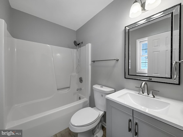 full bathroom featuring bathtub / shower combination, vanity, and toilet