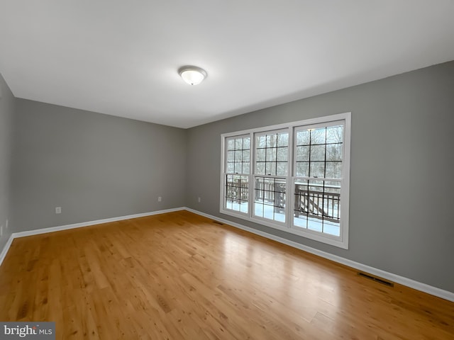 unfurnished room with light wood-type flooring