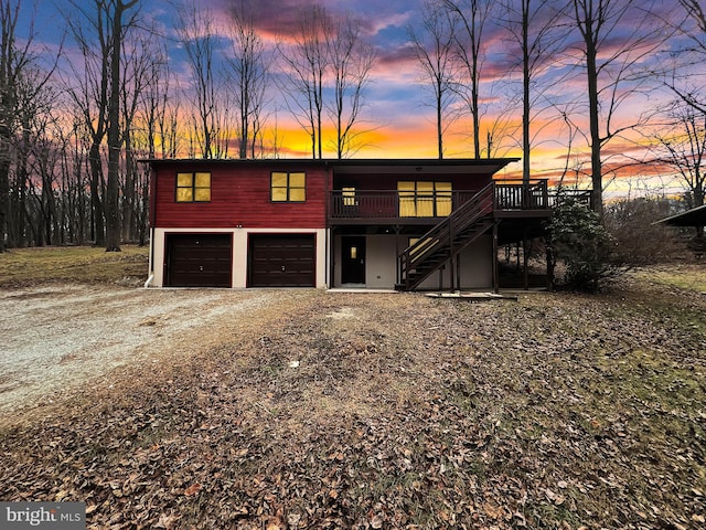 view of front of property featuring a deck and a garage