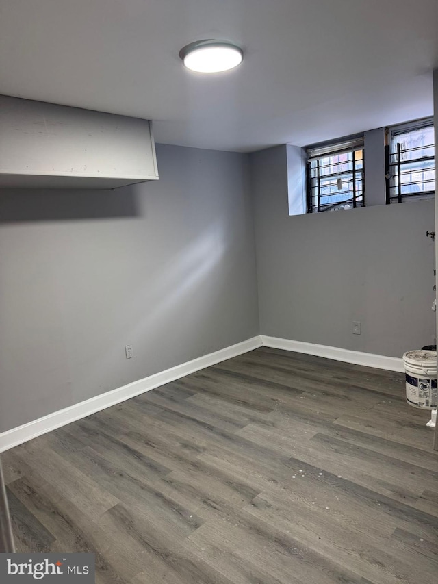 basement with dark hardwood / wood-style flooring