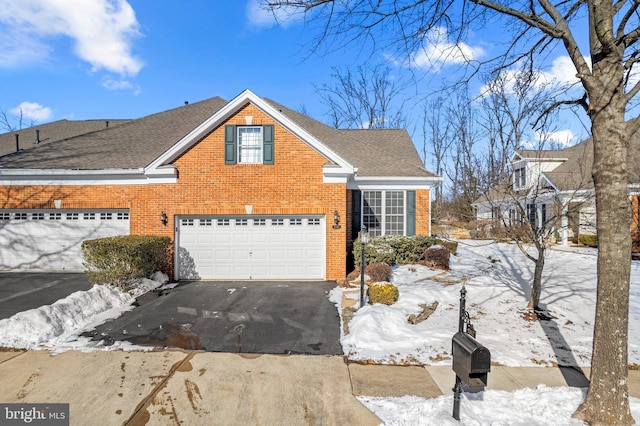 snow covered property with a garage