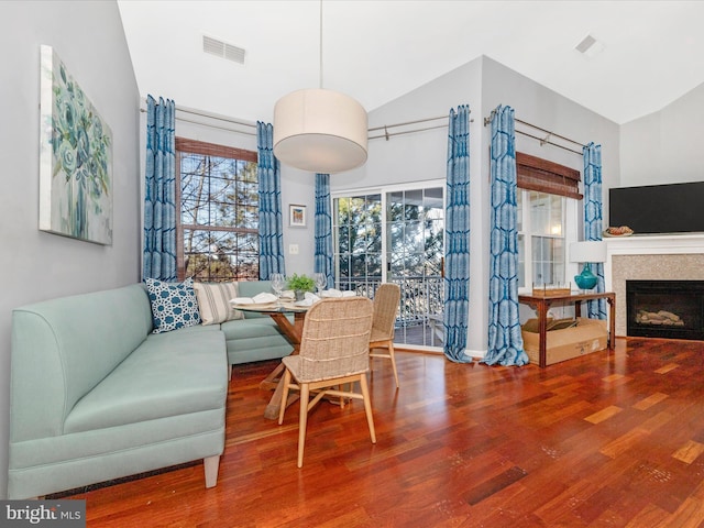 dining space featuring lofted ceiling and hardwood / wood-style floors