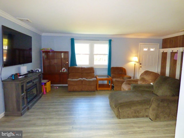 living room featuring ornamental molding and hardwood / wood-style flooring