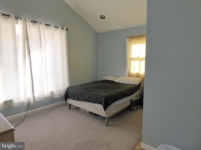 bedroom with vaulted ceiling and carpet flooring