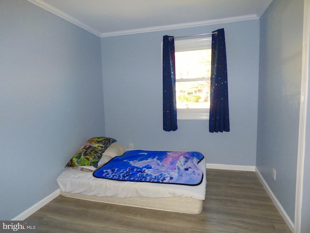 bedroom with crown molding and dark hardwood / wood-style floors