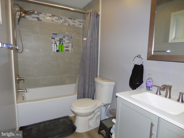 full bathroom featuring toilet, hardwood / wood-style floors, shower / tub combo with curtain, and vanity