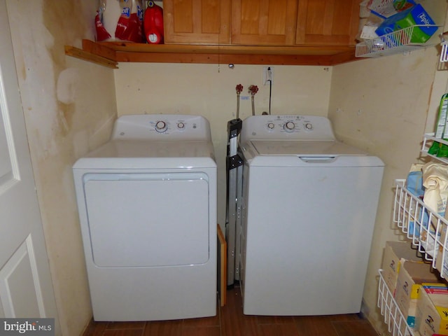 washroom with washer and clothes dryer and cabinets