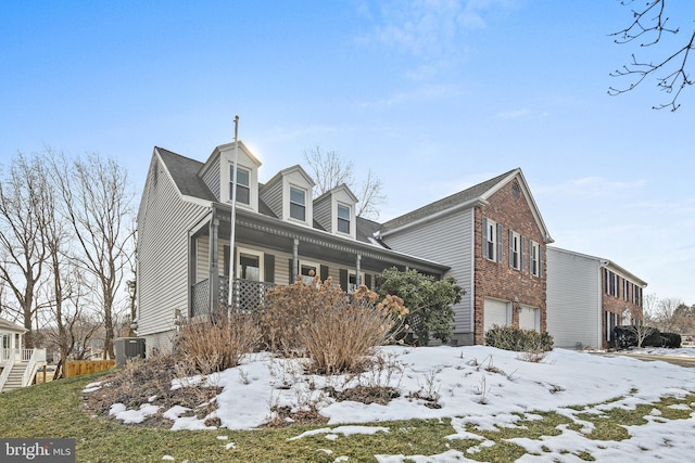 snow covered property with a garage