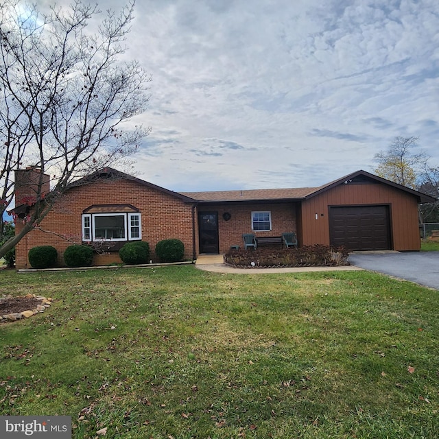 ranch-style home with a front yard and a garage