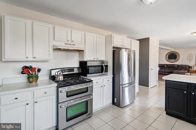 kitchen featuring appliances with stainless steel finishes, white cabinets, and light tile patterned floors