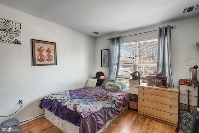 bedroom with wood-type flooring