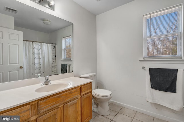 bathroom with toilet, tile patterned flooring, and vanity