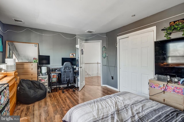 bedroom with a closet and hardwood / wood-style flooring