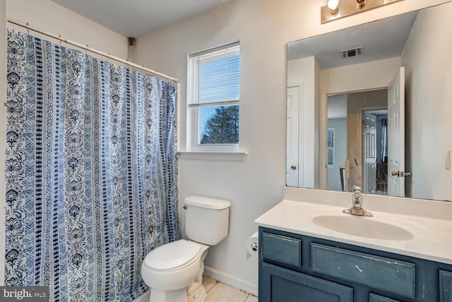 bathroom featuring toilet, tile patterned floors, and vanity