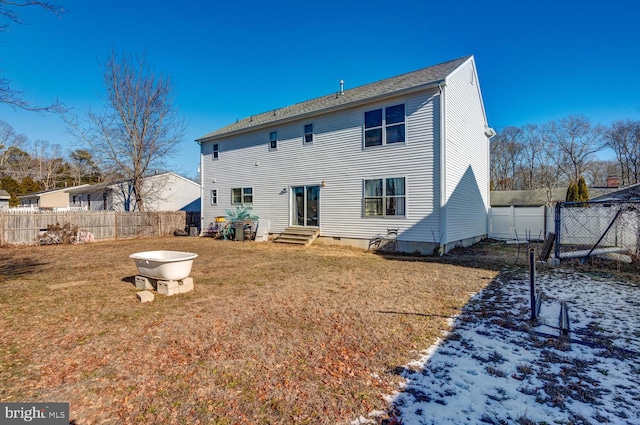 snow covered house featuring a yard